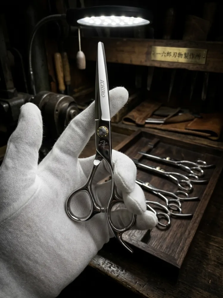 Shear maker in white gloves inspecting a finished blade